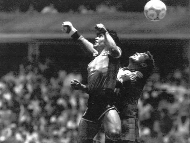 FILE - Argentina's Diego Maradona, left, beats England goalkeeper Peter Shilton to a high ball and scores his first of two goals in a World Cup quarterfinal soccer match, in Mexico City, on June 22, 1986.