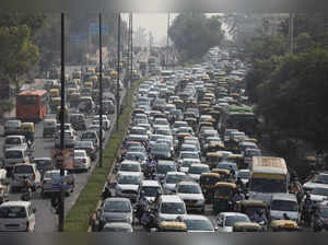 FILE PHOTO: Vehicles queue at a traffic light on a hazy morning in New Delhi