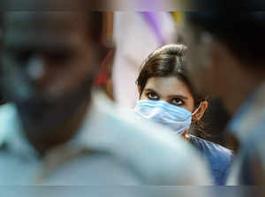 New Delhi: A woman wearing mask visits a market, in New Delhi. With COVID cases ...