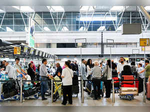 FILE PHOTO: People wait in lines at Schiphol Airport in Amsterdam, Netherlands