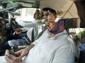 New Delhi: Bihar Dy CM and RJD leader Tejashwi Yadav leaves after appearing at a...