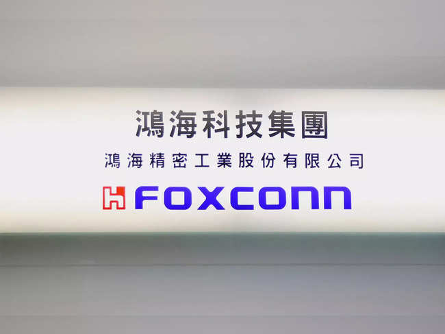 Sign of Foxconn is seen at a glass door inside its office building in Taipei