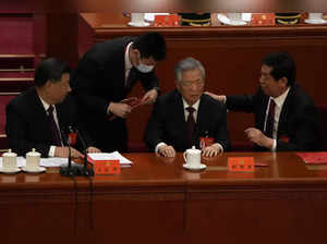 Former Chinese leader Hu Jintao, seated next to President Xi Jinping, escorted off stage during Communist Party congress