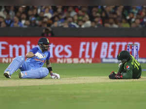 Pakistan's wicketkeeper Mohammad Rizwan, right, and India's Virat Kohli react du...