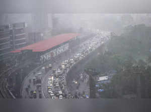 Mumbai: Vehicles ply on a road amid monsoon rains, in Mumbai. Incessant showers ...