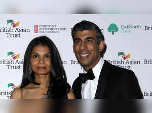 Britain's Chancellor of the Exchequer Rishi Sunak (R) poses with his wife Akshata Murthy AFP