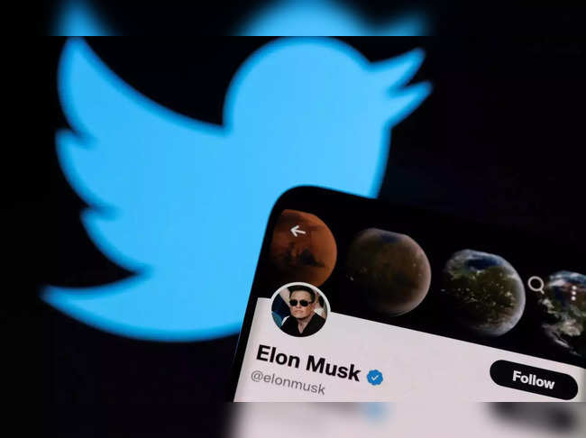 A photo illustration shows Elon Musk's twitter account and the Twitter logo.
