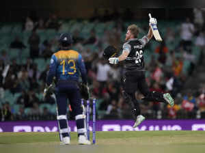 New Zealand's Glenn Phillips, right, jumps up in fromt of Sri Lanka's Kusal Mend...