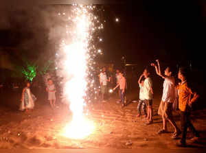 Children react as they light fireworks to celebrate Diwali in Mumbai