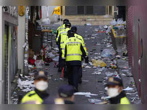 Police officers work at the scene of a fatal crowd surge, in Seoul, South Korea....