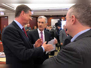FILE PHOTO: Federal Reserve Chairman Jerome Powell speaks with Chicago Fed President Charles Evans and St Louis Fed President James Bullard at a conference on monetary policy at the Federal Reserve Bank of Chicago