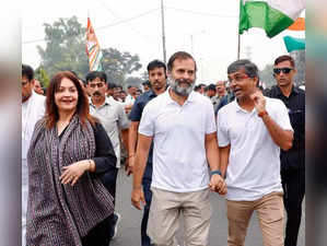 Actor-filmmaker Pooja Bhatt walks with Rahul Gandhi