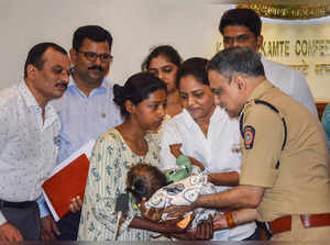 Mumbai: Mumbai Police Commissioner Vivek Phansalkar hands over a one-year-old gi...