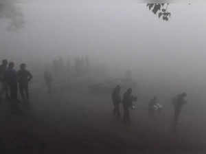 People on the banks of Yamuna River amid dense fog, in New Delhi. (PT...