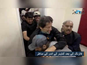 Former Pakistani Prime Minister Imran Khan is helped after he was shot in the shin in Wazirabad