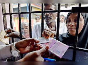 **EDS: FILE PHOTO** New Delhi: In this Nov. 12, 2016 file photo, people exchange...