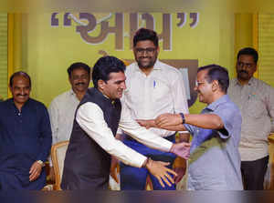 Ahmedabad: Delhi CM Arvind Kejriwal hugs Aam Aadmi Party (AAP) party’s chief min...
