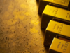 Gold inches lower; set for weekly gain on hopes of less aggressive Fed