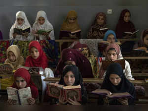Afghan girls read the Quran in the Noor Mosque outside the city of Kabul, Afghan...