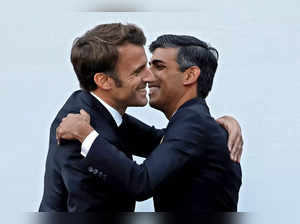 Britain's Prime Minister Rishi Sunak, right, hugs President of France, Emmanuel ...
