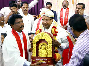 Kolar, Nov 13 (ANI): Congress leader Siddaramaiah being felicitated by a priest ...