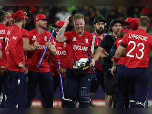 England's Ben Stokes, center, celebrates with teammates after hitting the winnin...
