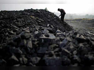 FILE PHOTO: Zhang Tieliang 76, sifts through dunes of low-grade coal near a coal mine in Ruzhou