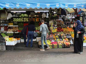 People shop for fruits and vegetables in Damascus