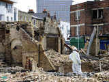 Workan stands guard beside a ruined shop