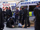 Policemen hold an inebriated man