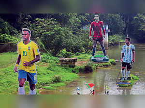 Football fans at a village in Kerala wave flags next to huge cut-outs of (from left) Brazil’s Neymar, Argentina’s Lionel Messi and Portugal’s Cristiano Ronaldo
