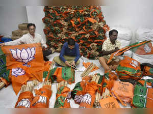 Rajkot: Bharatiya Janata Party (BJP) workers prepare party flags for campaigning...