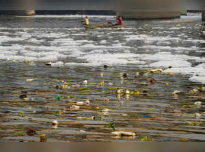 New Delhi: Garbage and toxic foam float on the surface of polluted Yamuna river,...