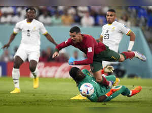 Doha: Portugal's Cristiano Ronaldo, up, falls over Ghana's goalkeeper Lawrence A...
