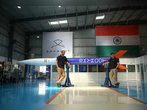 Pawan Chandana and Bharath Daka pose for a photograph with a mockup of Vikram-S rocket in Hyderabad