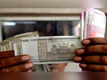 Rupee gains as dollar slides on U.S. data backing slower rate hikes