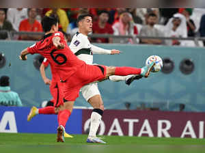 Al Rayyan :Portugal's Cristiano Ronaldo, and South Korea's Kim Young-gwon vie for the ball during the World Cup group H soccer match between South Korea and Portugal, at the Education City Stadium in Al Rayyan , Qatar, Friday, Dec. 2, 2022.(Photo:Suman Chattopadhyay/IANS/Image Solution)