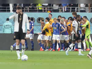 Doha : Japan's Ritsu Doan, center left, celebrates after scoring his side's open...