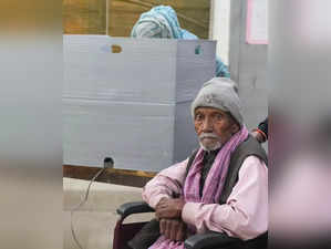 A voter waits to cast his vote for the Municipal Corporation of Delhi...