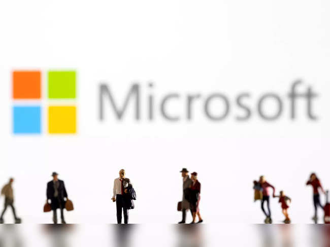 Illustration shows small figurines and displayed Microsoft logo