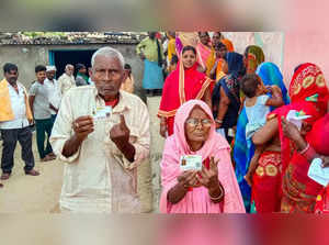 Mokama: Voters show their ink-marked fingers after casting their votes for the M...
