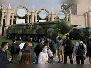 Visitors tour past military vehicles carrying the Dong Feng 41 and DF-17 ballist...
