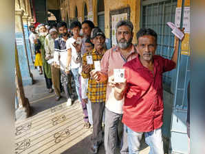 Ahmedabad: Voters stand in a queue to cast their vote for Gujarat assembly elections, in Ahmedabad on Monday, Dec. 05, 2022. (PHOTO: IANS/Siddharaj Solanki)