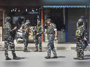 Srinagar: CRPF personnel stand guard as security has been beefed up during Union...