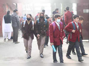 Srinagar, Nov 30 (ANI)_ Students leave the school premises on a cold winter day ....