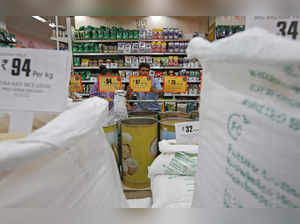FILE PHOTO: A worker arranges price tags of the food products at a store inside a shopping mall in Kolkata