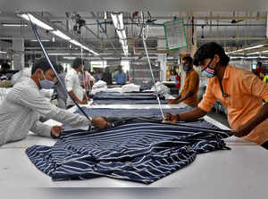 FILE PHOTO: Garment workers cut fabric to make shirts at a textile factory of Texport Industries in Hindupur