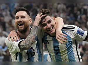 Argentina's Lionel Messi, left, and Argentina's Julian Alvarez celebrate after s...
