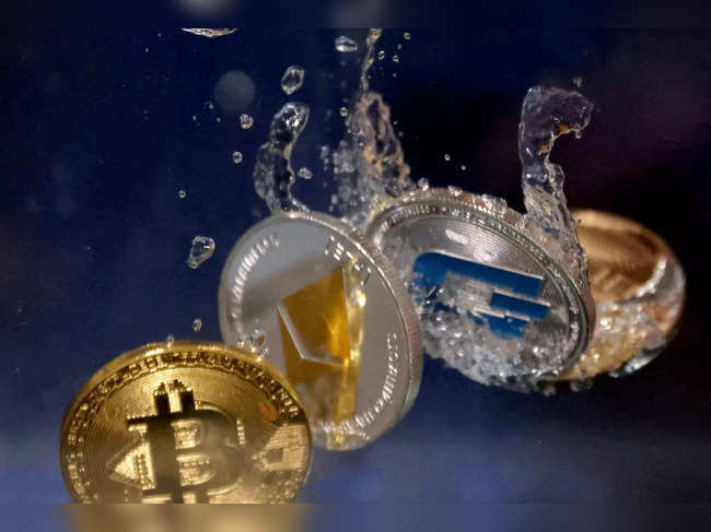 FILE PHOTO: Illustration shows representation of cryptocurrencies plunging into water