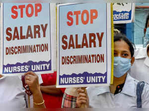 Kolkata: Members of Nurses Unity raise slogans during a protest demanding equal ...